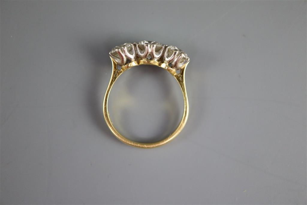 A modern 18ct gold and three stone brilliant cut diamond ring,